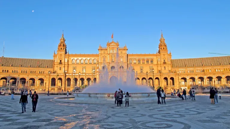 A view of the architecture and a water fountain in Plaza de Espana